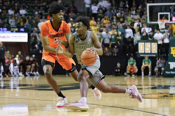 Baylor Bears guard LJ Cryer is defended by Oklahoma State Cowboys guard Woody Newton